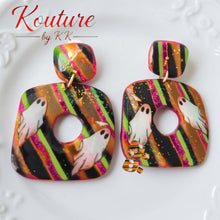 Load image into Gallery viewer, Pair of colorful polymer clay post dangle earrings with white ghosts and striped orange, pink, green, and black designs
