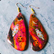 Load image into Gallery viewer, Colorful Halloween earrings with ghost, bat, and jack-o’-lantern designs on a purple and orange background
