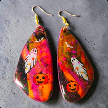 Load image into Gallery viewer, Pair of glittery Halloween earrings with ghost, bat, and pumpkin artwork on a gray marble background
